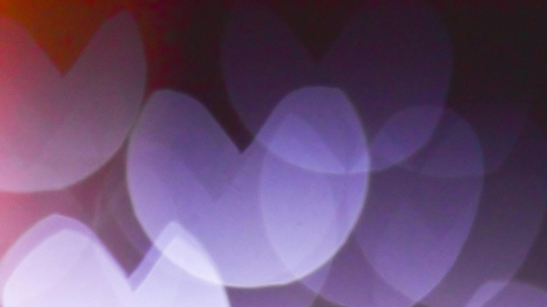 Abstract background with soft purple gradients and subtle light patterns.